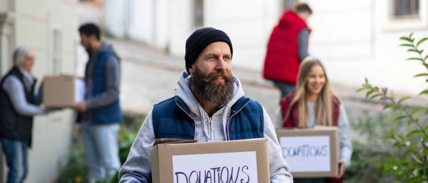diverse-group-of-volunteers-with-donation-boxes-standing-outdoors-social-care-and-charity-concept.jpg